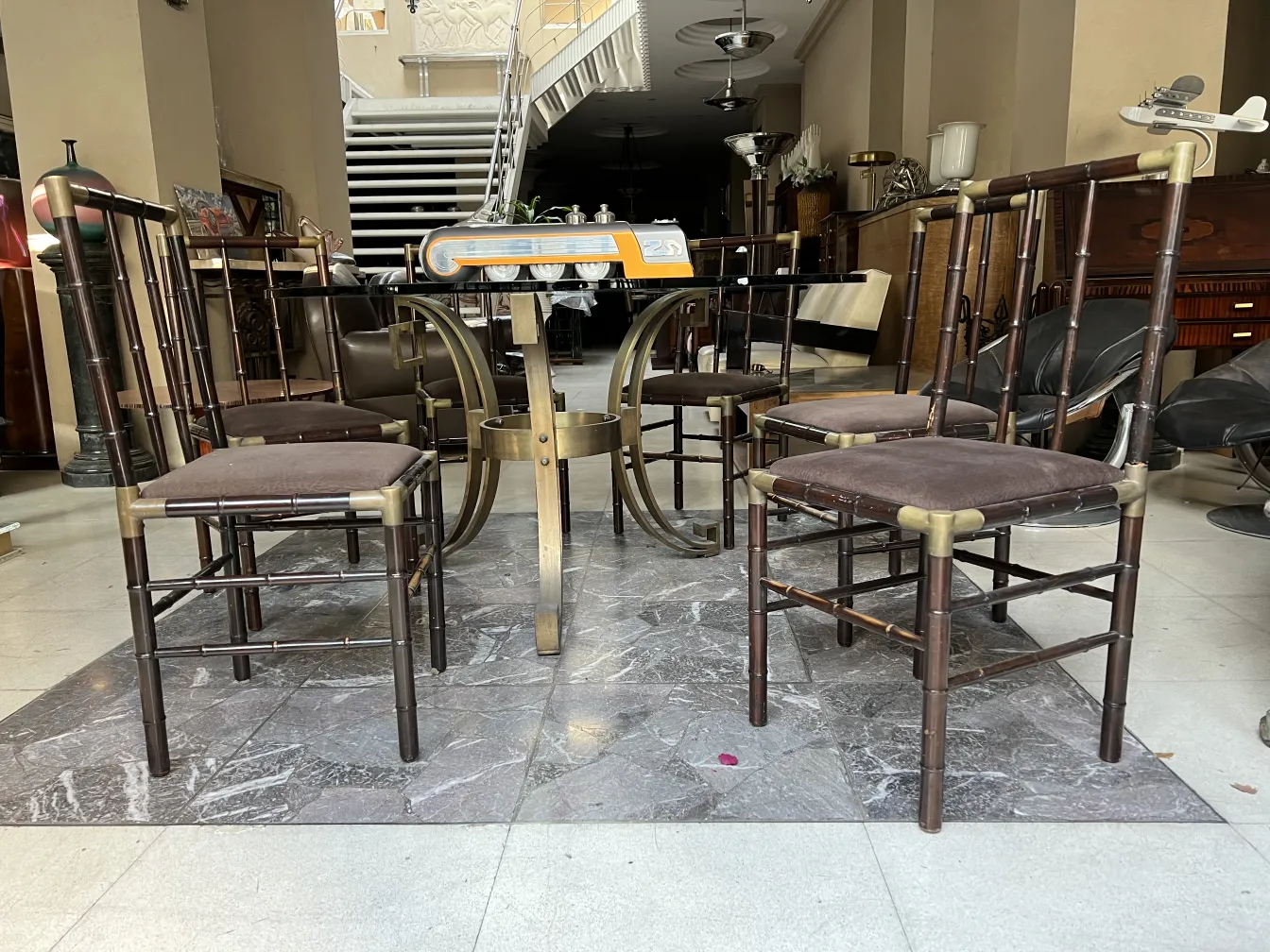 6 antique chairs in an elegant space with modern decor.