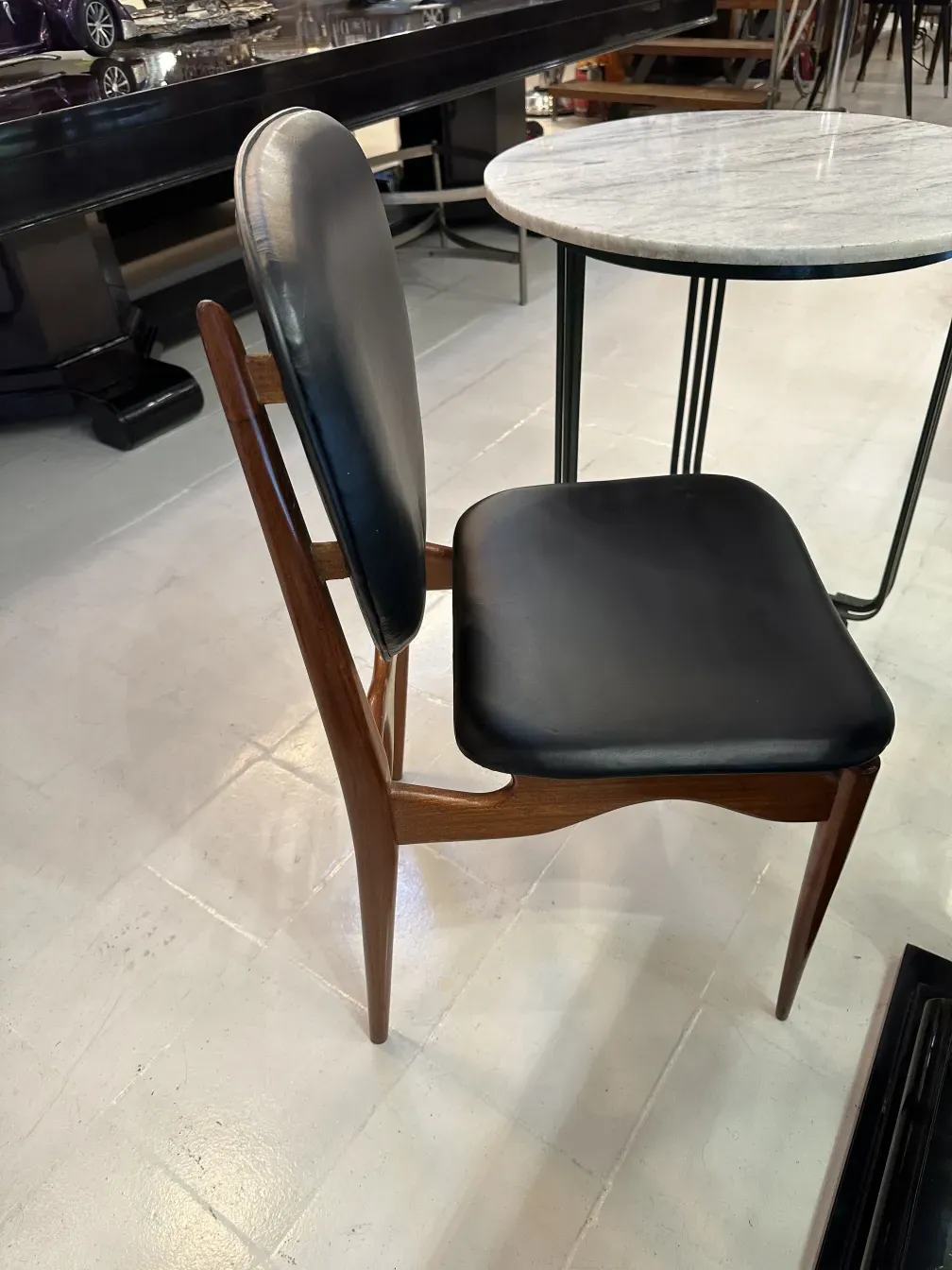 Side view of 8 antique chairs in an elegant setting