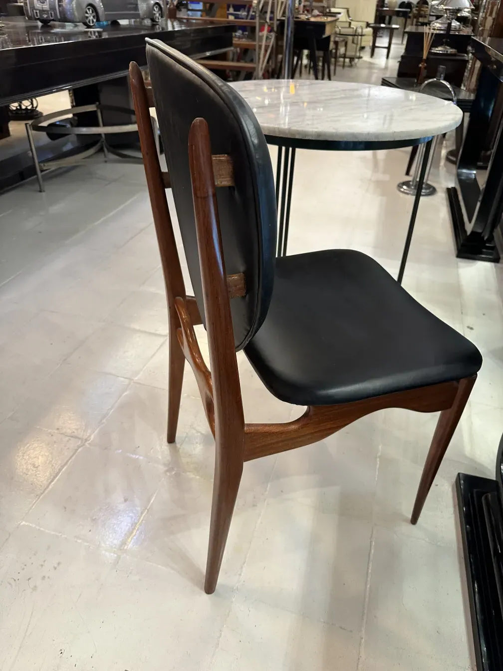 Antique chairs arranged in a vintage setting, finn juhl style