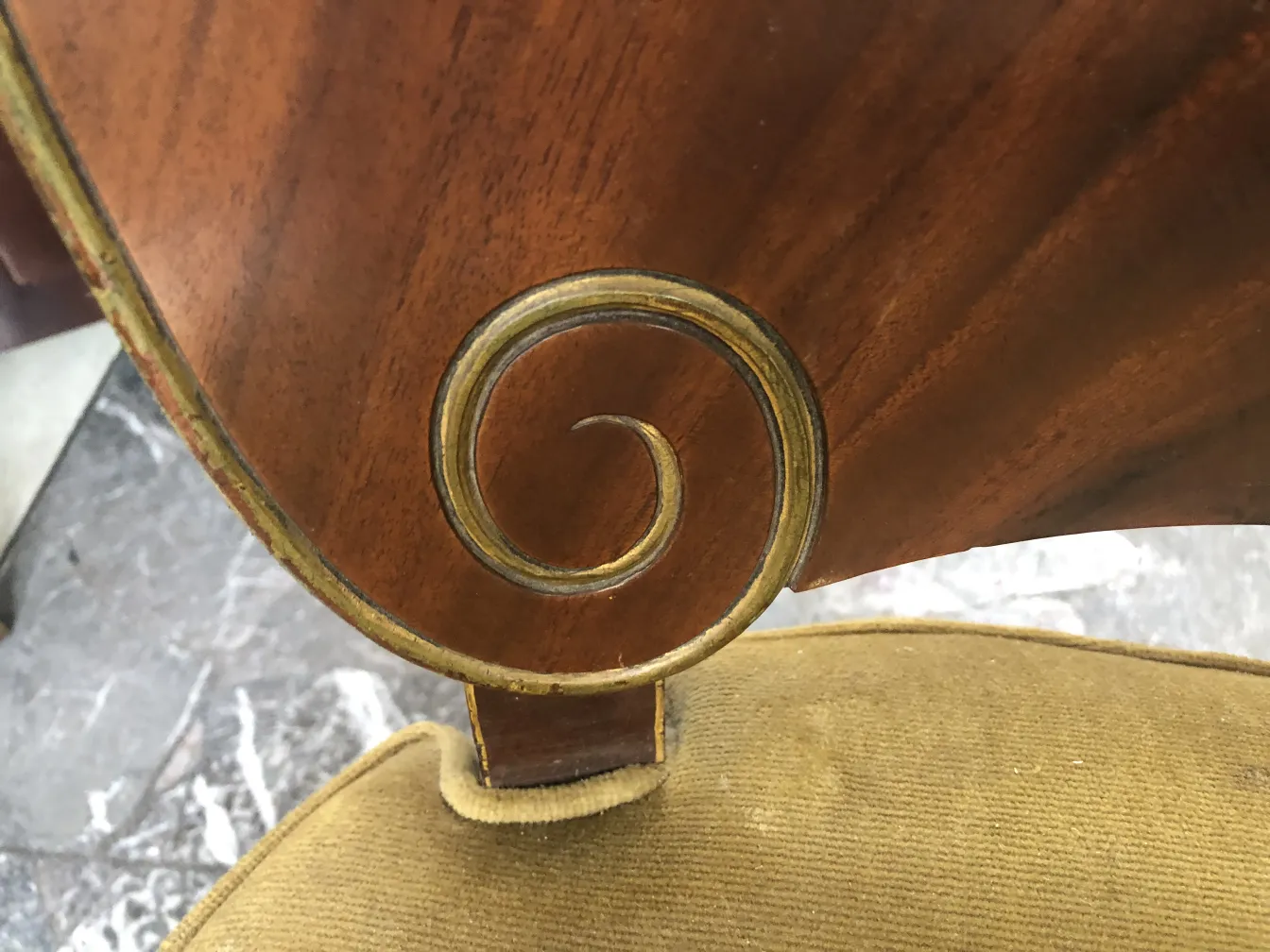 Close-up of 12 antique jansen chairs with intricate decorative design.