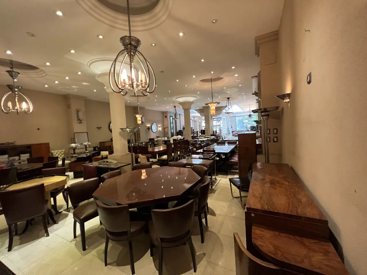 View of 12 antique chairs in a cozy environment with tables