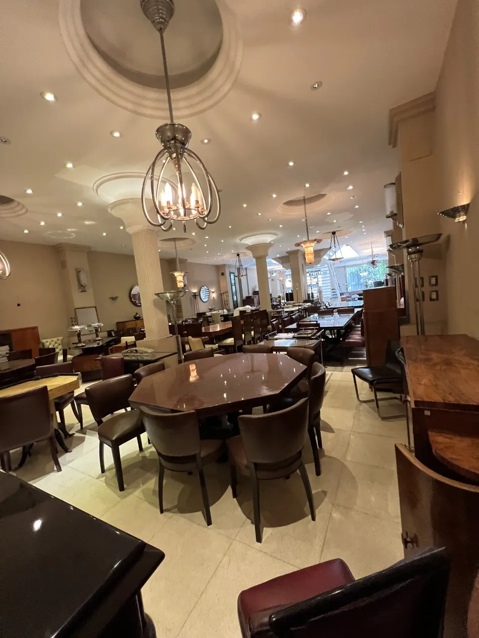 View of 12 antique chairs in an elegant environment with a table