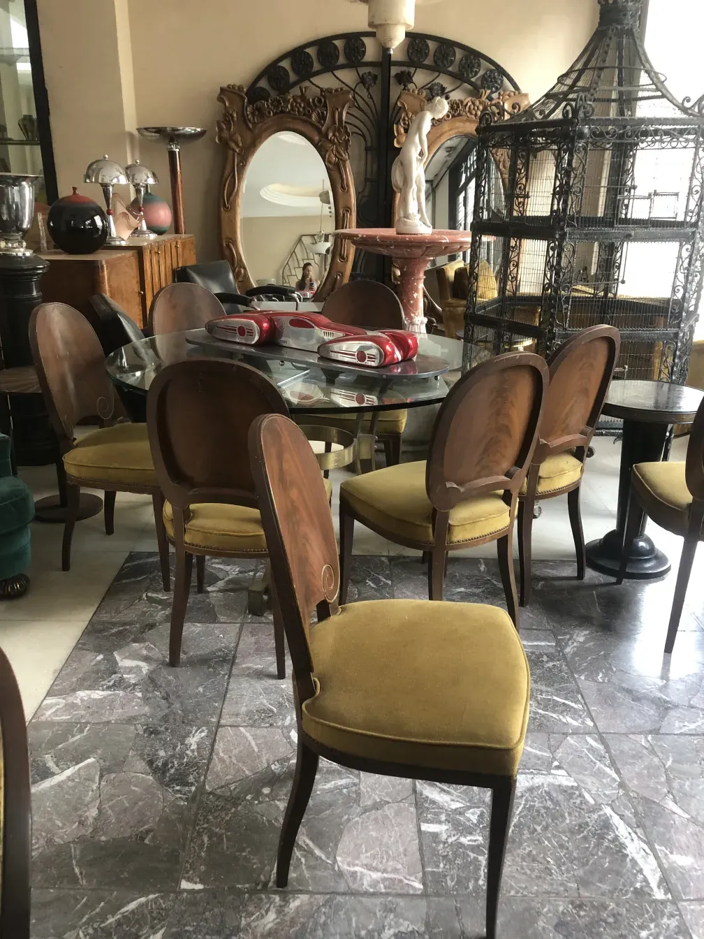 12 antique chairs in a classic setting with decorative accessories.