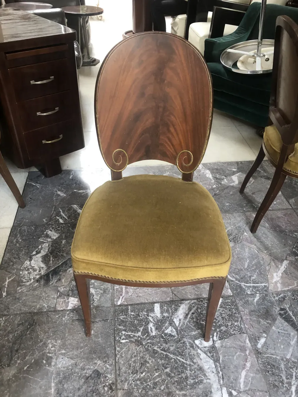 Antique jansen chairs with an elegant design and a curved back in a modern setting.