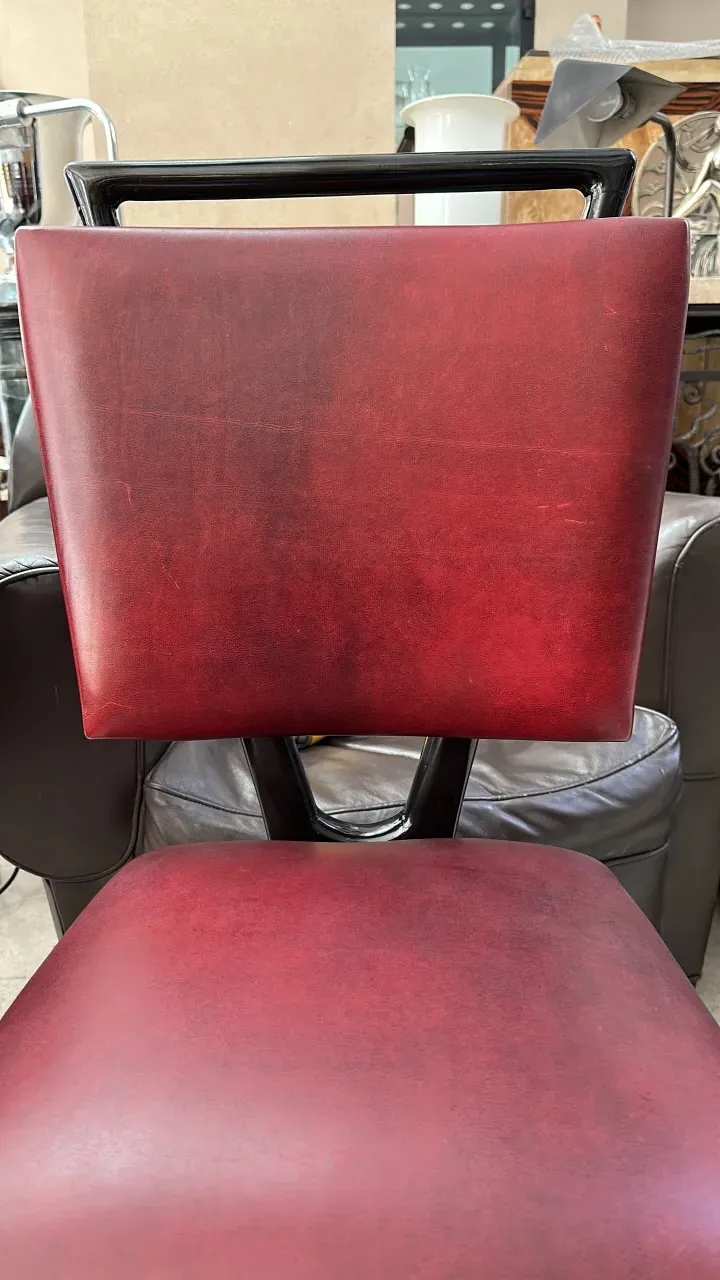 12 antique chairs of various colors in a cozy setting