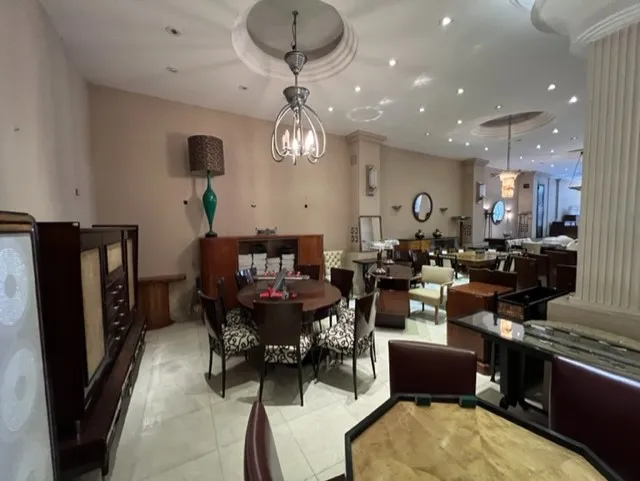 View of 12 antique chairs in an elegant room