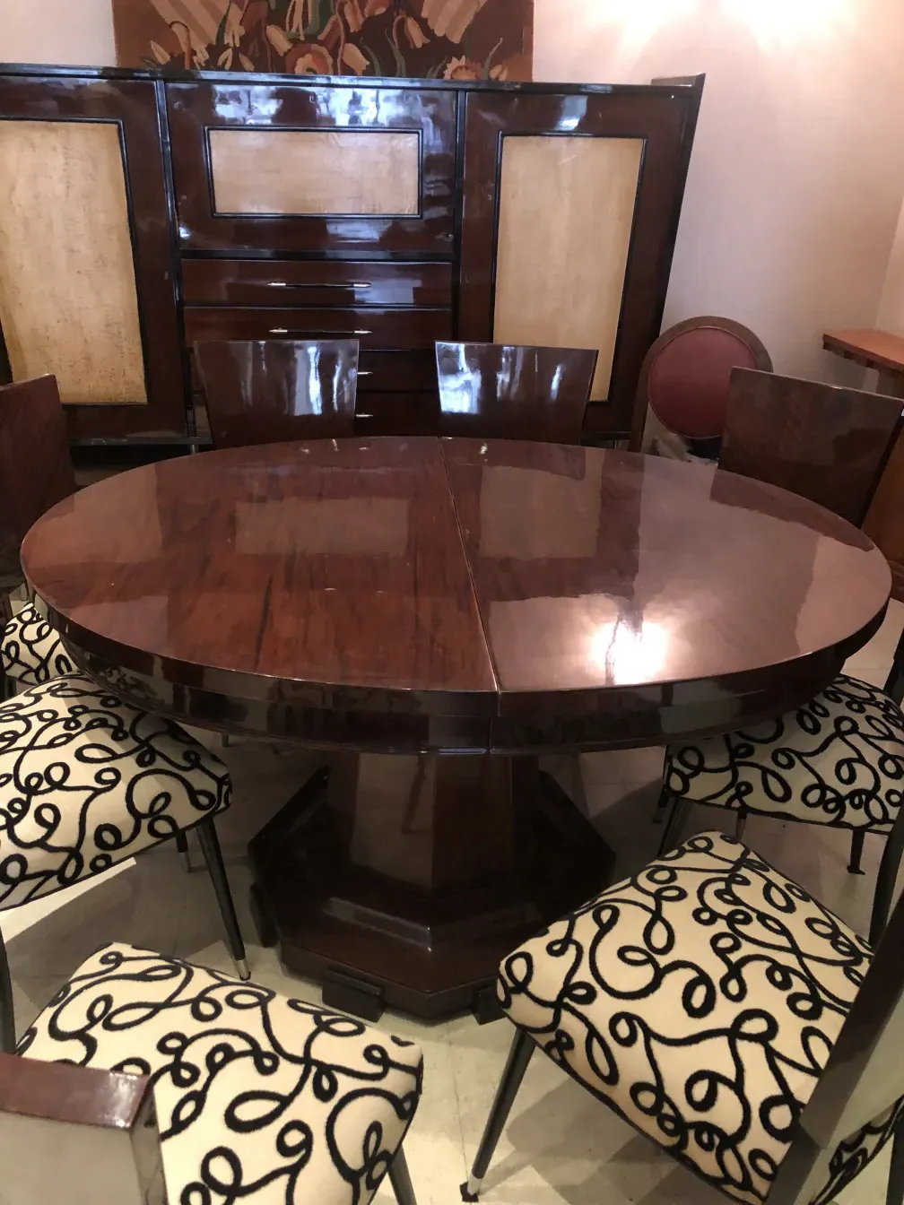 View of a set of 12 antique chairs with decorative design in an elegant setting.