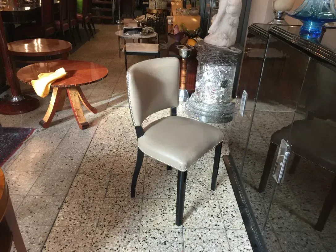 side view of 12 antique chairs in a cozy setting