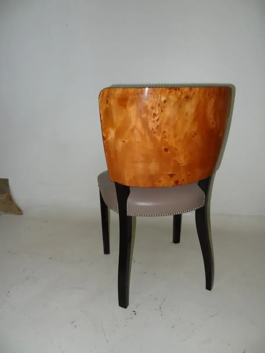 Side view of 12 antique chairs in a neutral setting