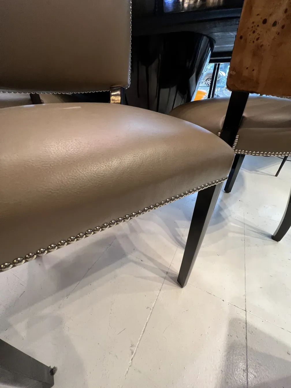 Side view of 12 antique chairs with elegant design in a contemporary setting