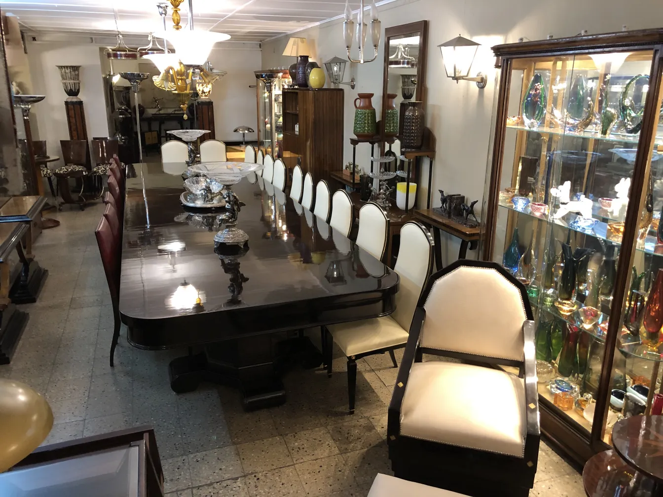 12 antique chairs in an elegant dining room with a long table and decorative items