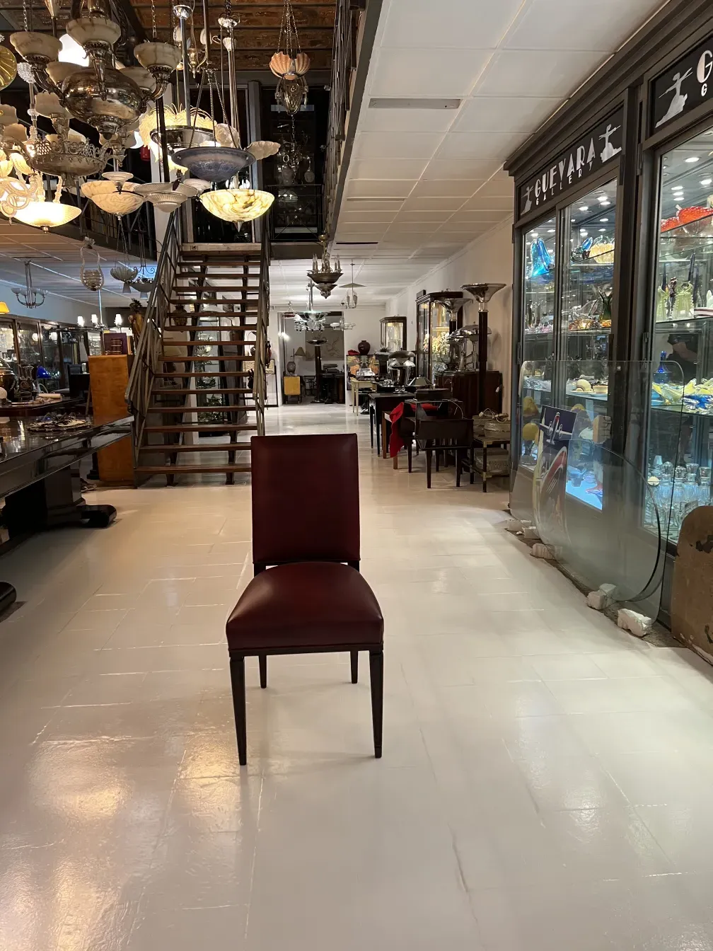 12 antique chairs displayed with decorative background