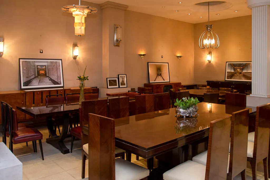 Dining room showcasing 12 antique chairs and elegant decor