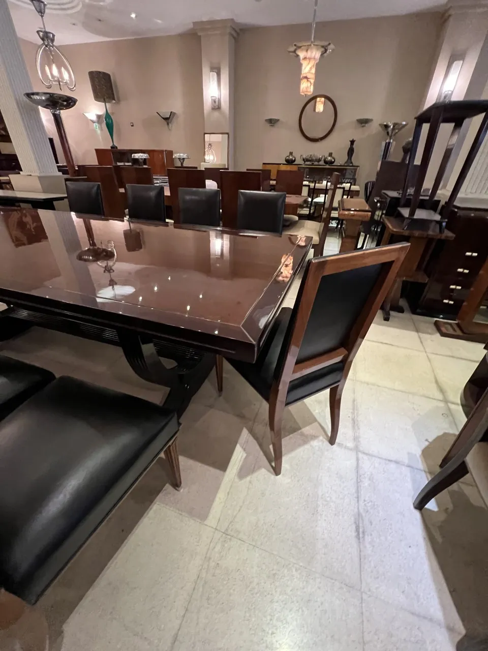 12 antique chairs with black upholstery in an elegant setting