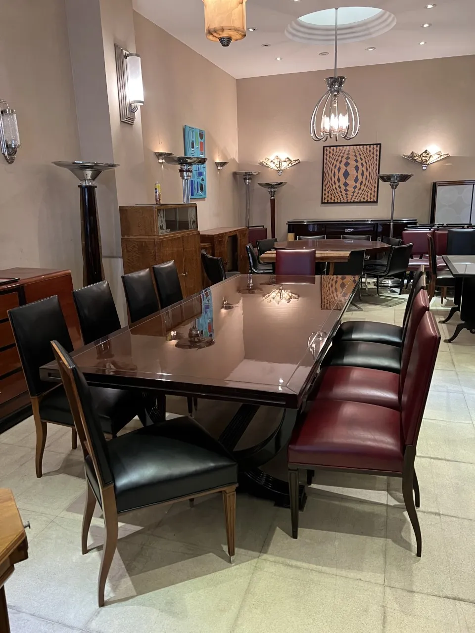 12 antique chairs in various colors within an elegant setting