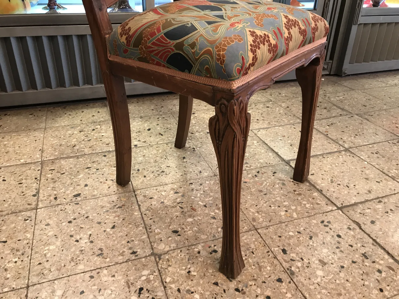 Antique decorative chair with beautiful upholstery and slender legs, in a cozy environment.