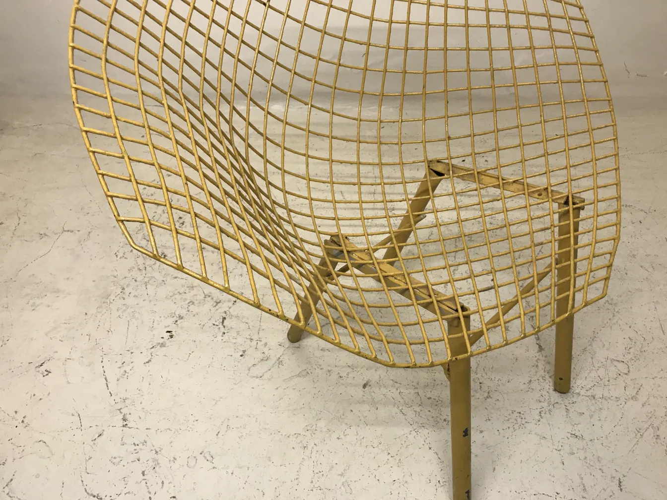Views of 3 antique yellow garden armchairs with a mesh design. Ideal for outdoor settings.