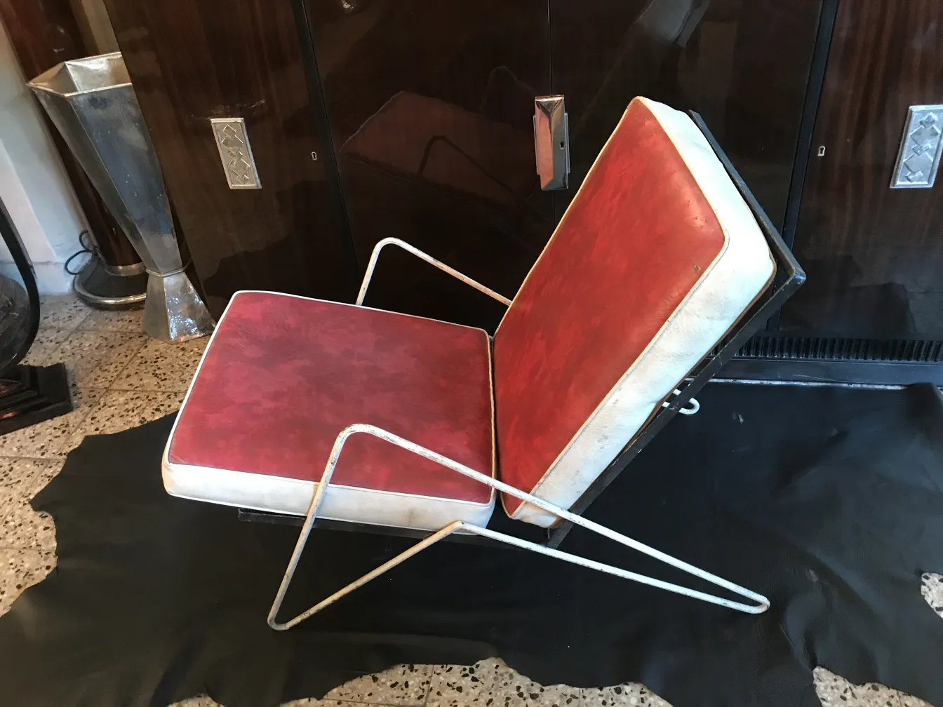 4 antique garden armchairs with red cushions in an elegant setting