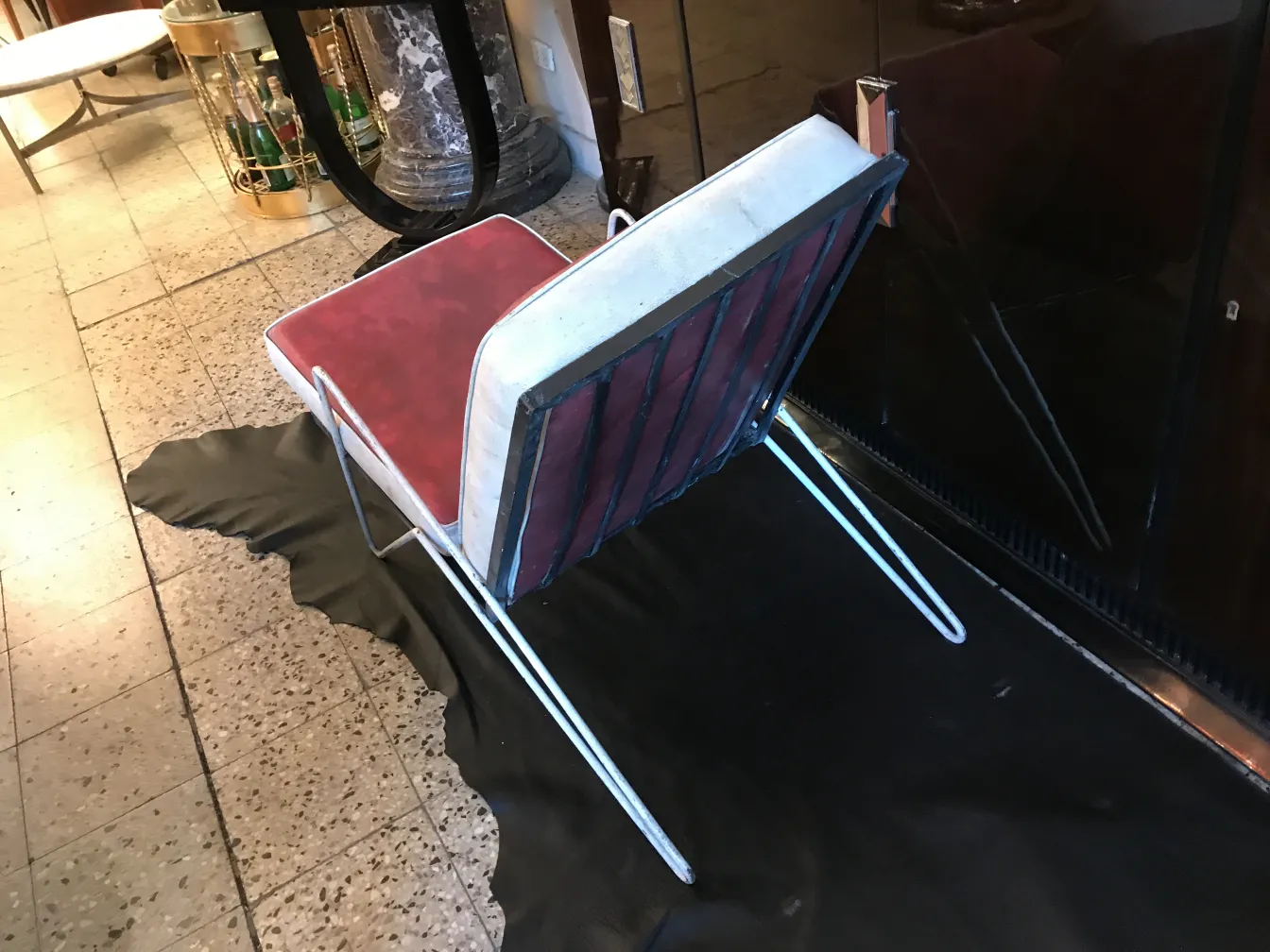 4 antique garden armchairs with red cushions and white backrest, in an elegant setting