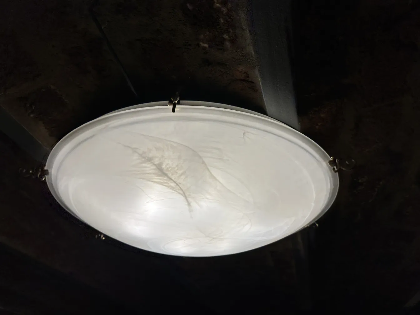 four antique round ceiling lights illuminating a space