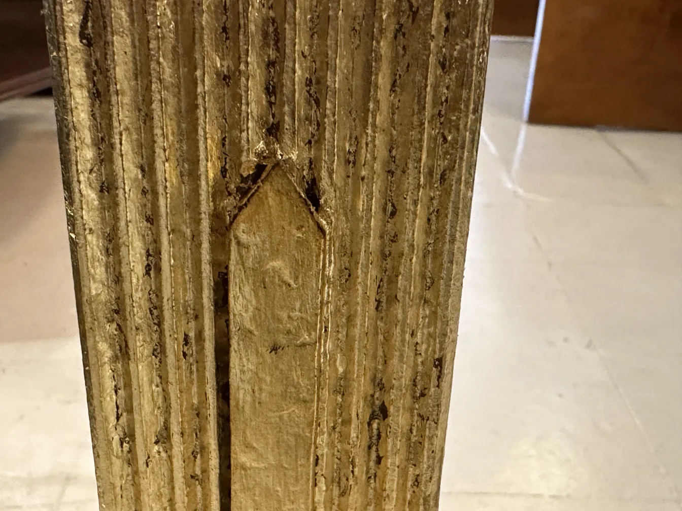 Antique golden umbrella stand with decorative details