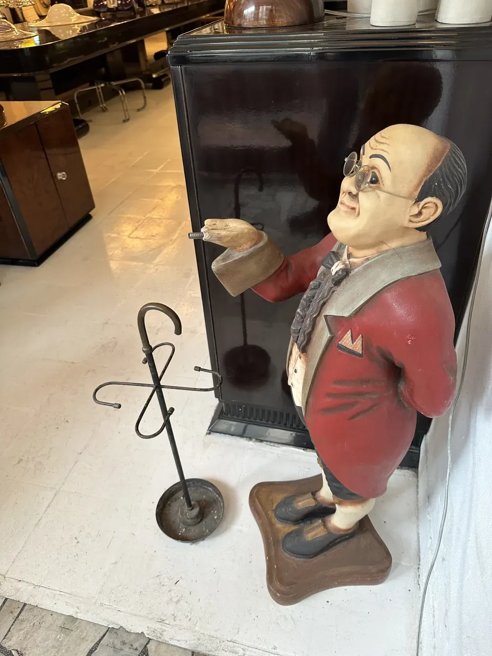 antique umbrella stand featuring a well-dressed man, decorative