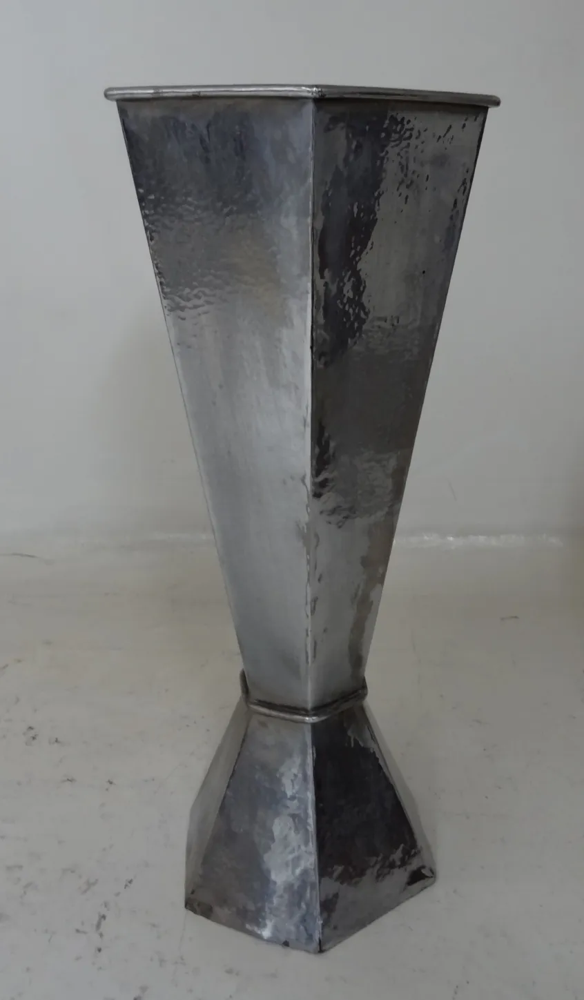 Antique umbrella stand with an elegant shape and shiny surface.