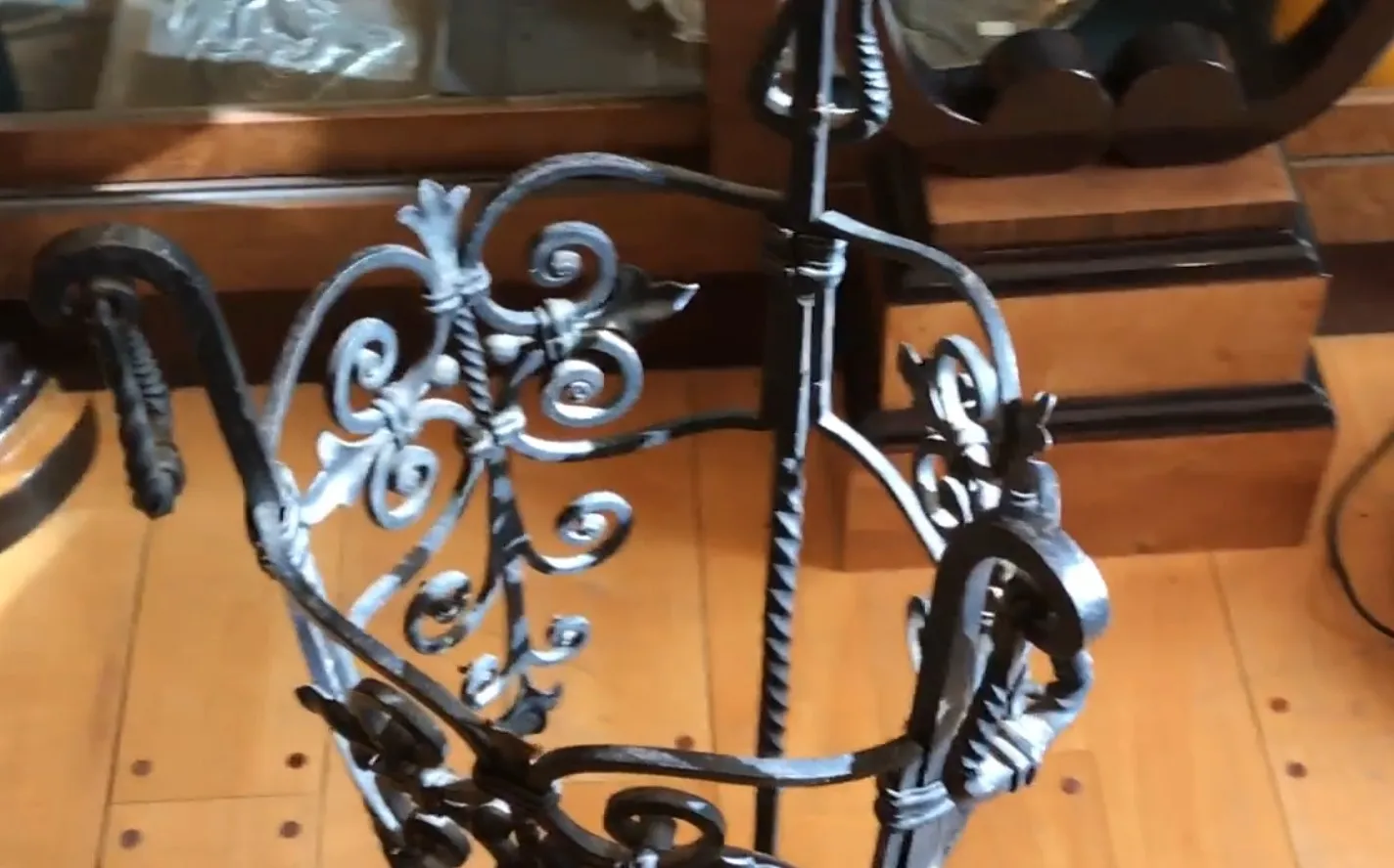 antique decorative umbrella stand with elegant iron details, wooden background