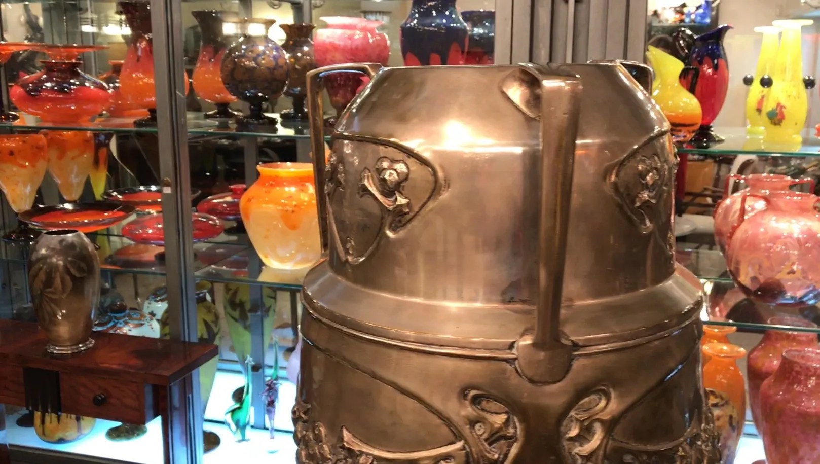 antique kayser umbrella stand, surrounded by colorful vases