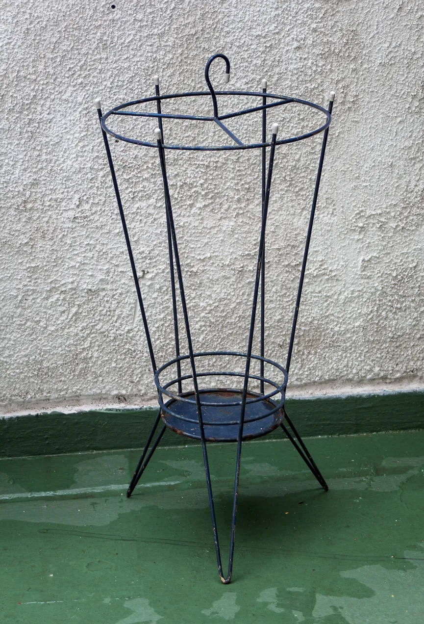 Antique umbrella stands with a simple design in a neutral setting