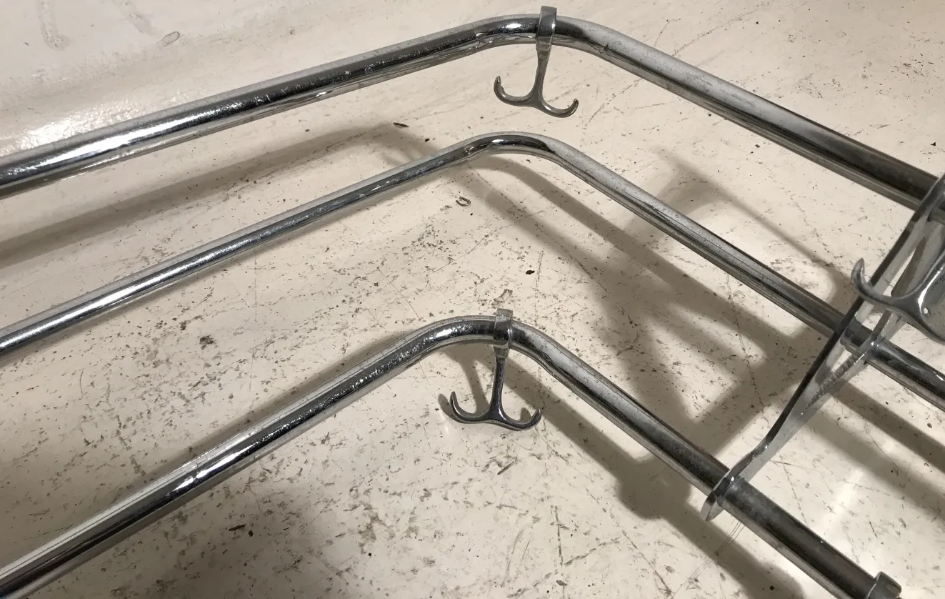 Antique coat rack with hooks on a light surface