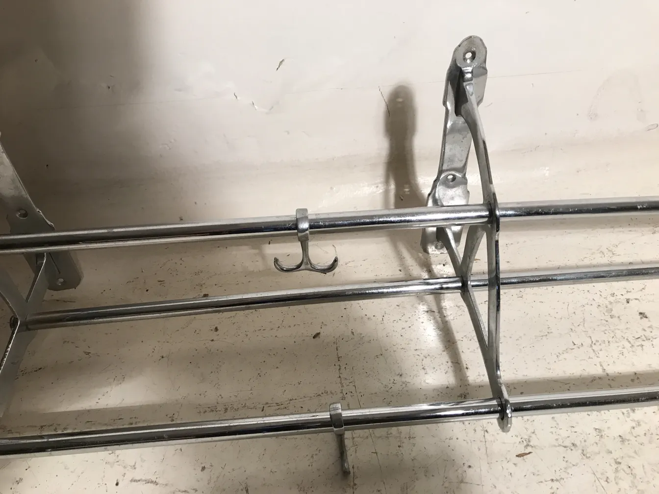 antique coat rack with metal structure and hooks