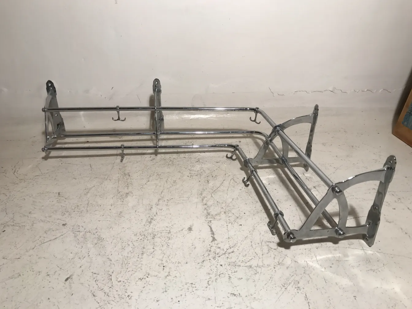 antique metal coat rack with hooks, neutral background