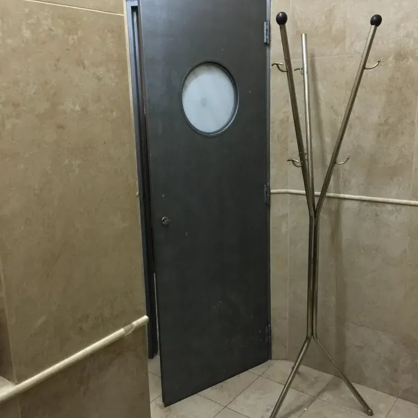 perchero antiguo con ganchos en un baño