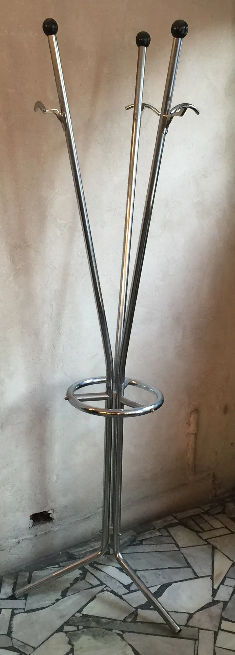 Antique coat rack with elegant hooks in a simple setting