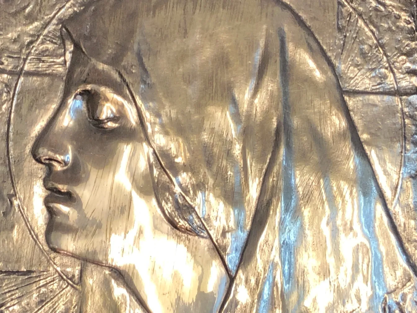 Antique wall plate with relief of a face