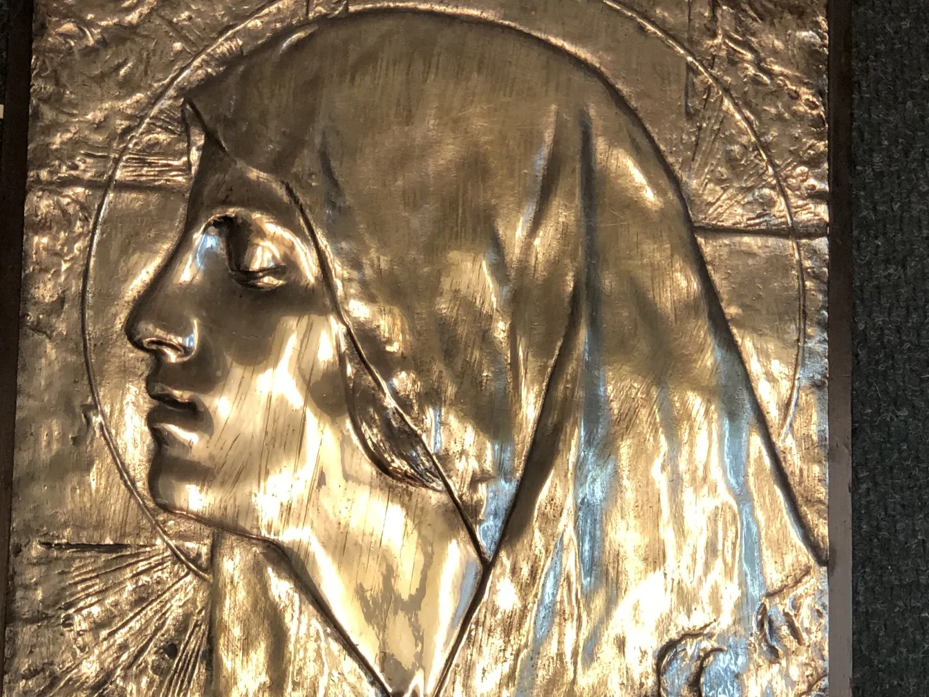 antique wall plate featuring religious relief in gold