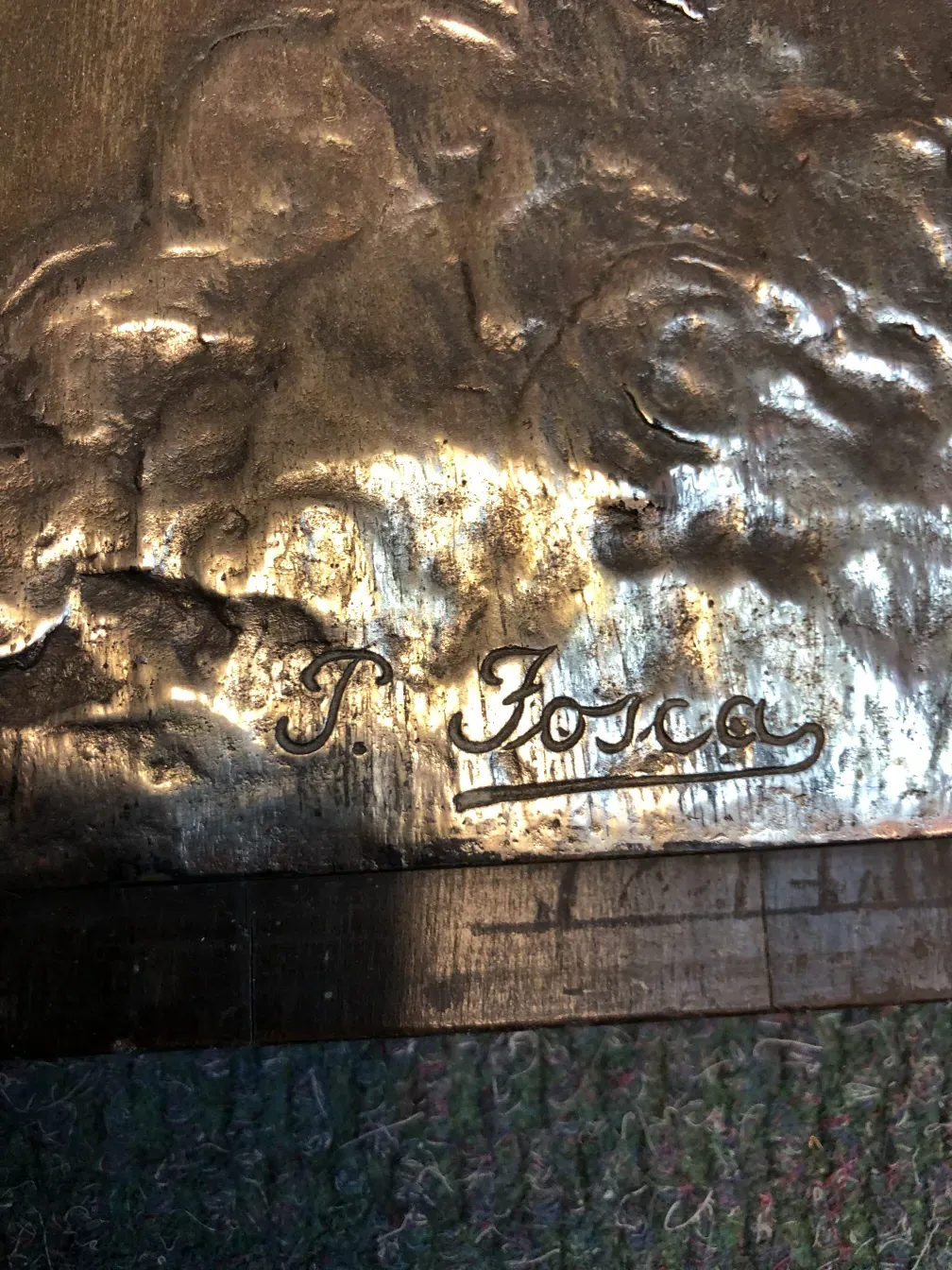 Antigua placa de pared con detalles en relieve, firmada por P. Fosca.