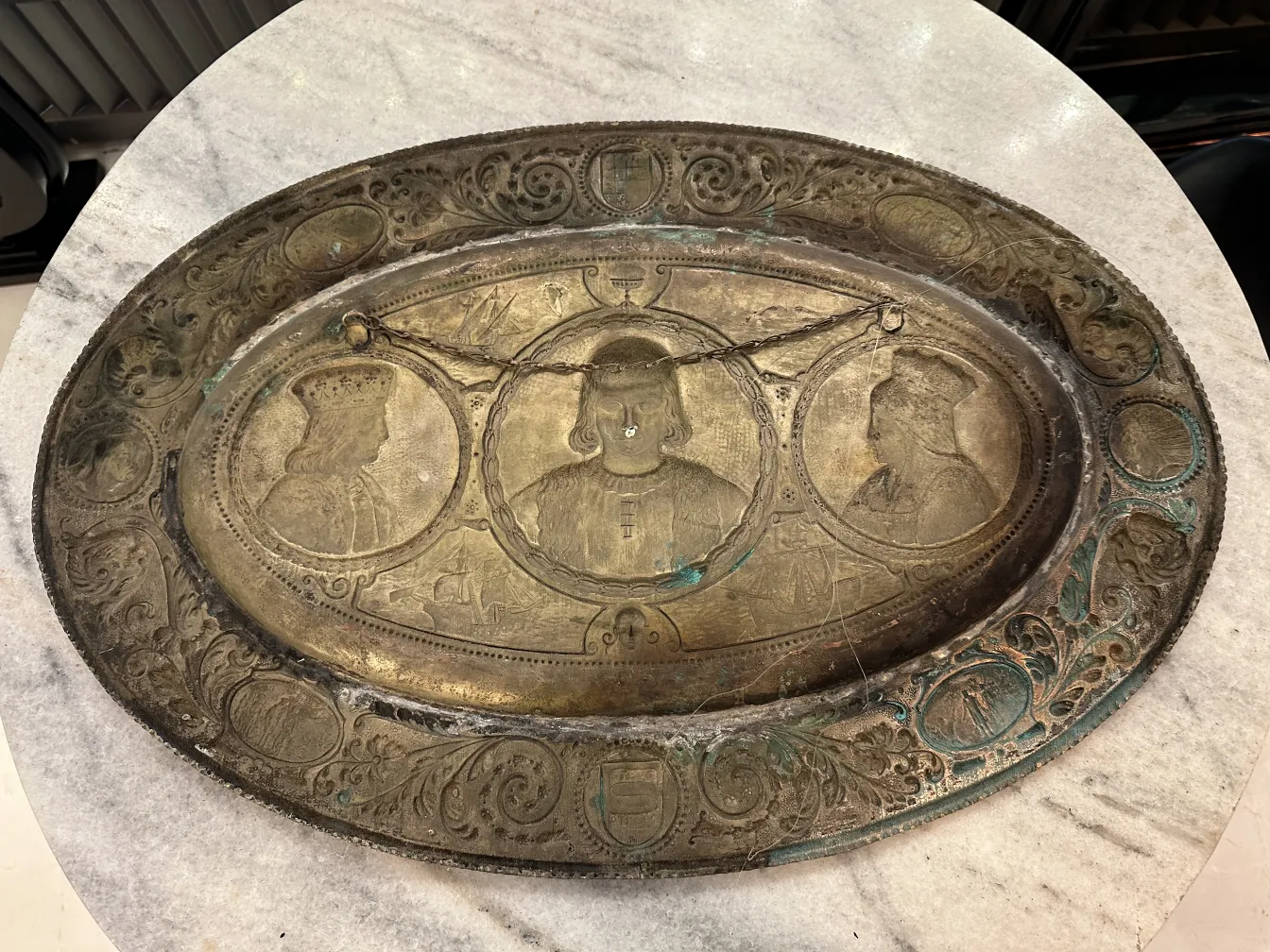 Antique wall plate decorated with sculpted figures