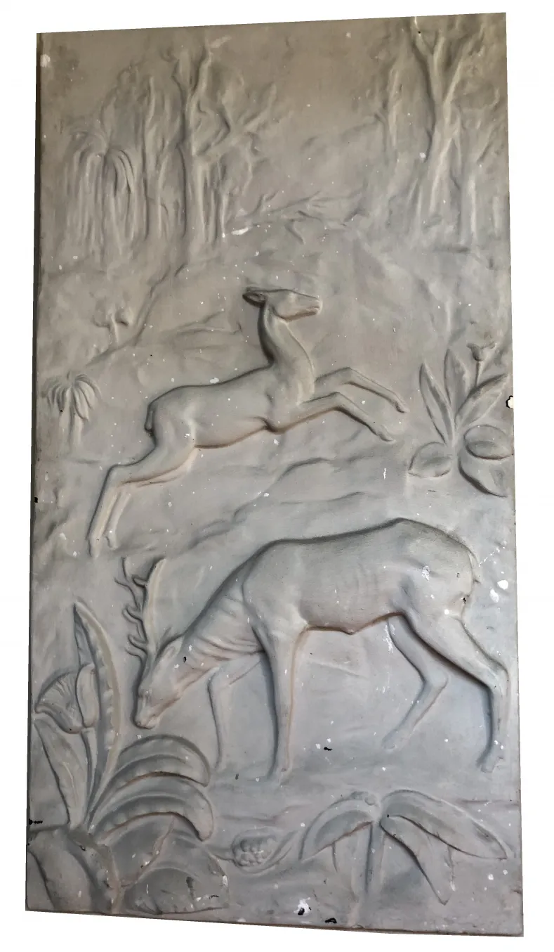 Antique wall plate featuring raised deer and greenery.