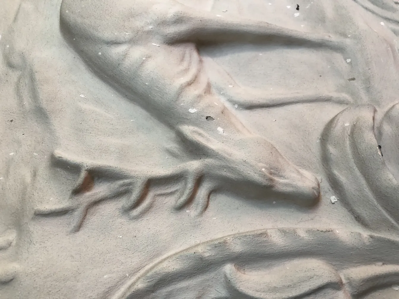 detail of an antique wall plate with decorative textured reliefs