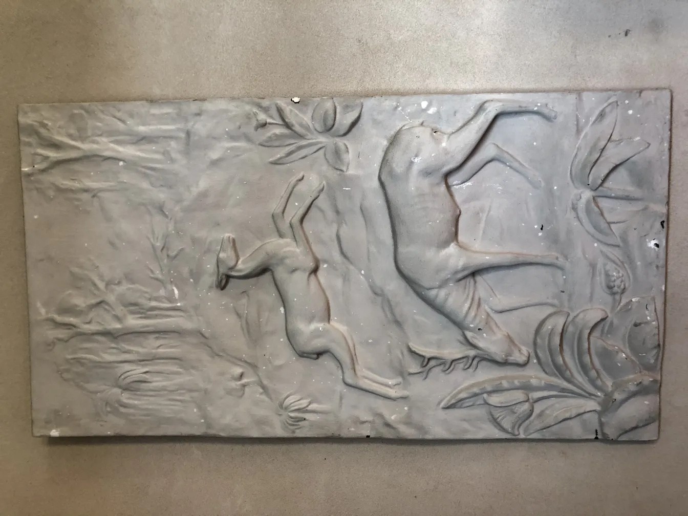 antique wall plate featuring reliefs of a deer and a rabbit