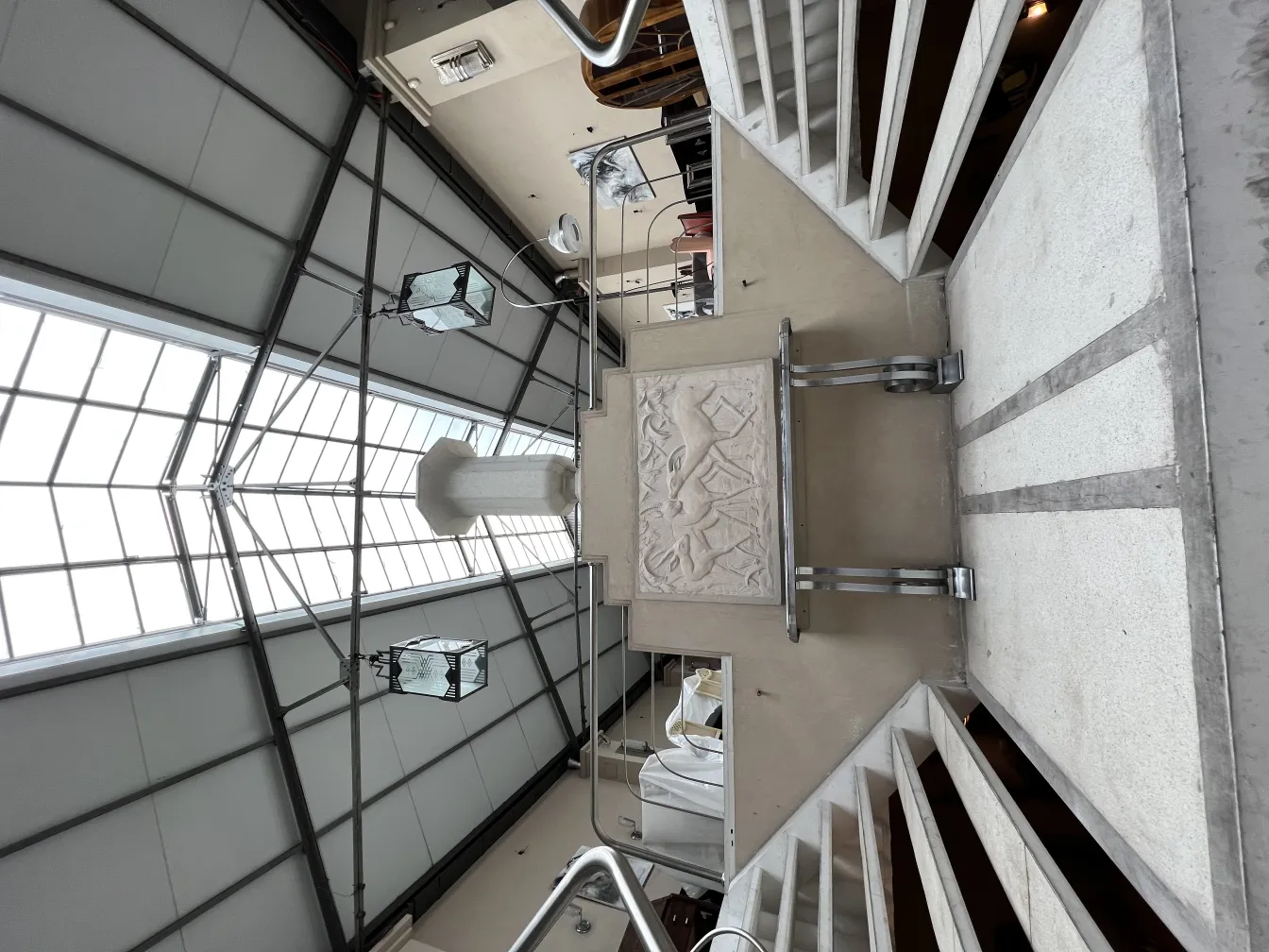 Placca a muro antica con rilievi in un ambiente moderno.