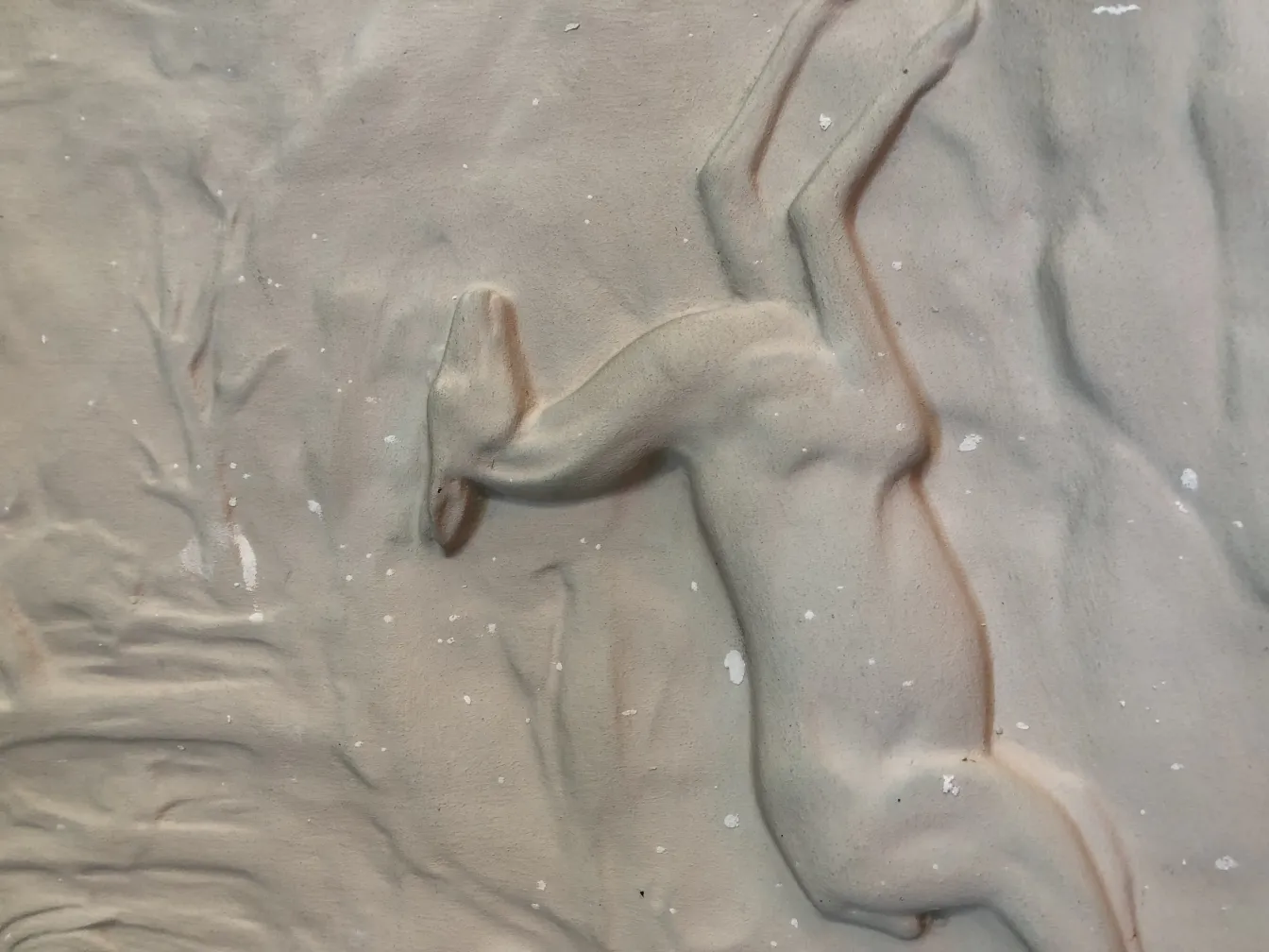 Antique wall plate with relief, featuring soft colors and subtle decorations in an ethereal setting.