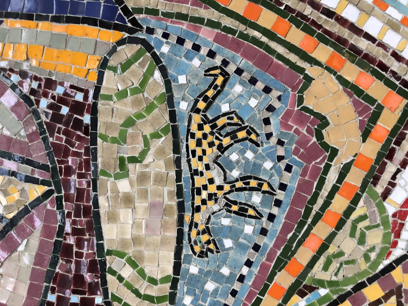 Antique mosaic panel featuring bright colors and varied shapes.