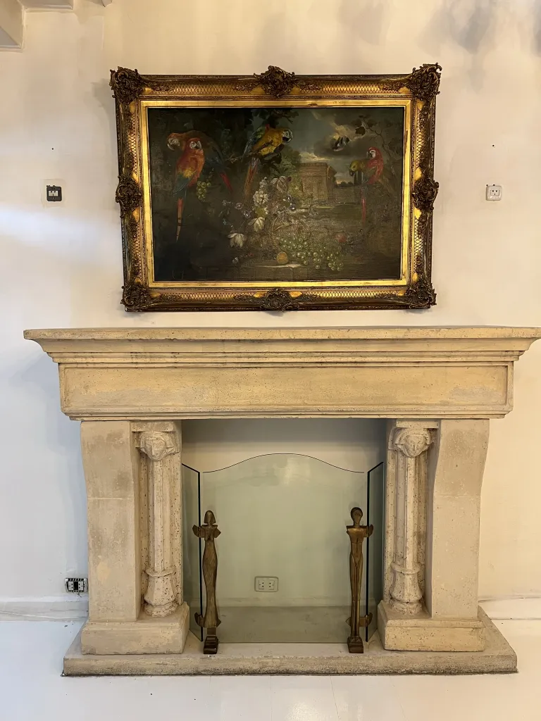 Antique painting of colorful birds in a golden frame