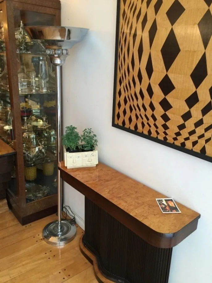 Coin de salle avec marqueterie ancienne et plante décorative.