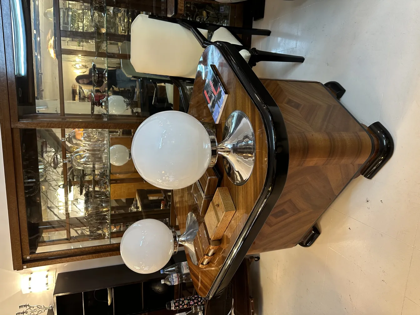 Two antique table lamps with round shades on a table