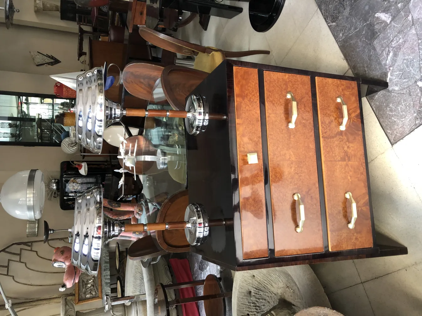 Two antique table lamps with elegant design, surrounded by various furniture.