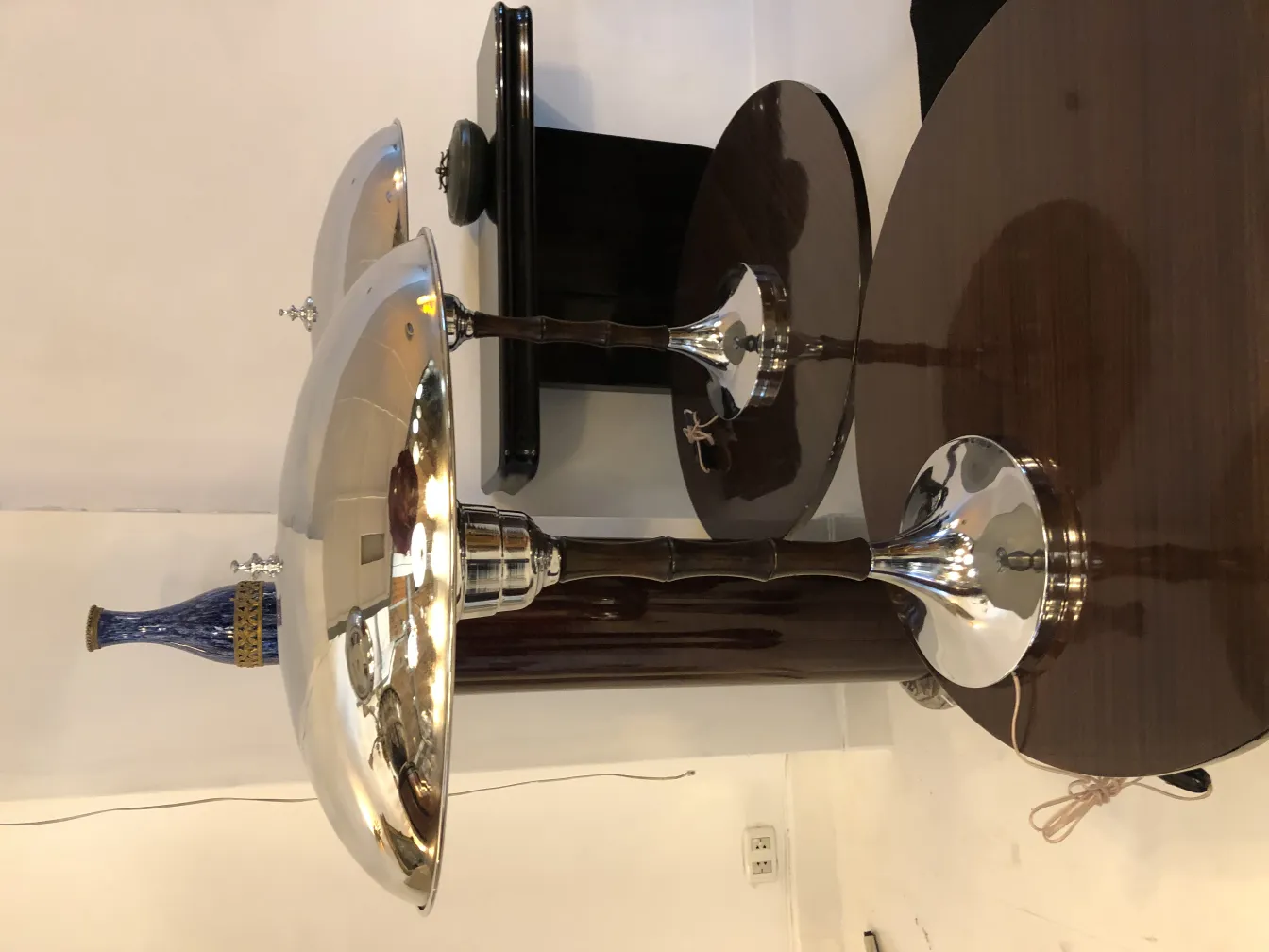 two table lamps with shiny bases and wide shades in a neutral setting